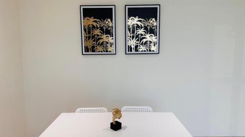 a doll sitting on a white table with two pictures at Sunday Sheikh Zayed Road Concord Tower by Belvilla in Dubai