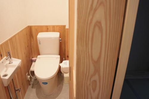 a bathroom with a toilet and a sink at Ito Ryokan in Tokyo