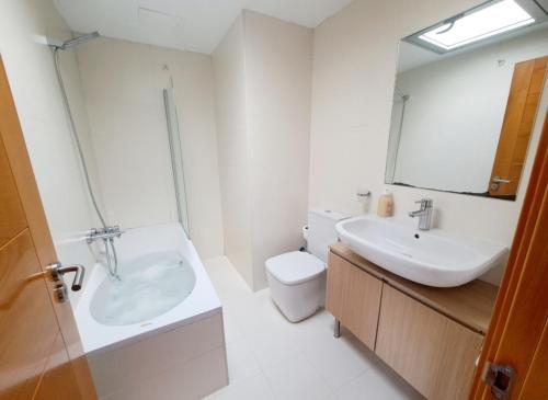 a bathroom with a sink and a toilet and a mirror at Pont Vell in Montblanc