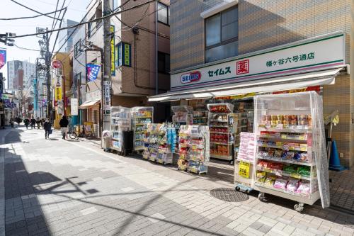 a street with a grocery store on the side of a building at LEGA LAND Hatagaya in Tokyo
