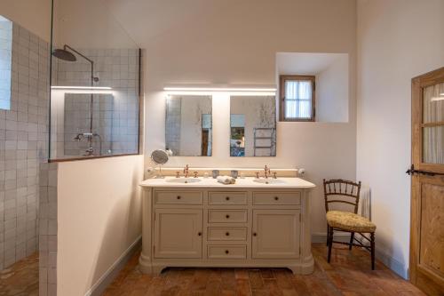 a bathroom with a sink and a mirror at La Bastide in Oppède