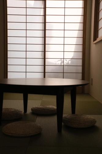 a table sitting in front of a large window at Ito Ryokan in Tokyo