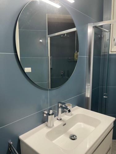 a bathroom with a sink and a mirror at Casa Direttamente sul mare in Marina di Mancaversa