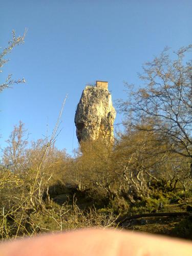 a rock formation with a house on top of it at Giorgi's Homestay in Kutaisi