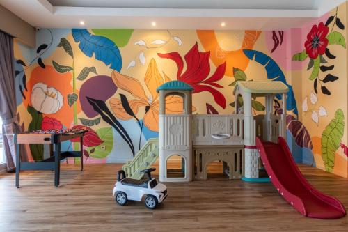 a play room with a mural of flowers at Bustle Base Coliving and Coworking Space in Legian