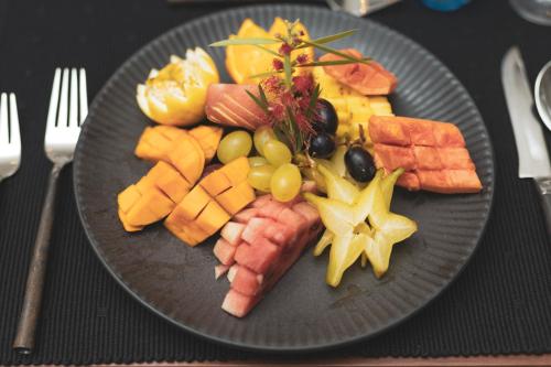 a plate of food with meats and vegetables on a table at Heritage Boutique by Seven Angels in Kandy