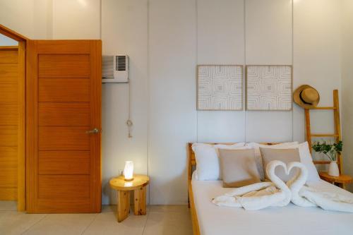 a bedroom with a bed with two towels on it at Bali-inspired Villa with Dipping Pool by Pallet Homes in Iloilo City