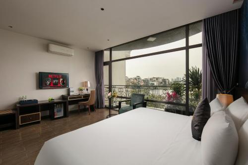 a hotel room with a bed and a large window at Westlake Pearl Suites & Spa 70 Xuan Dieu - By Pegasy Group in Hanoi