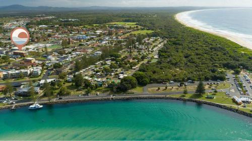 an aerial view of a beach with a hot air balloon at Bowling Greens in Tuncurry