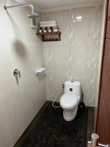a small bathroom with a toilet in a room at Shri Wedari Private Pool with Ricefield View in Tampaksiring