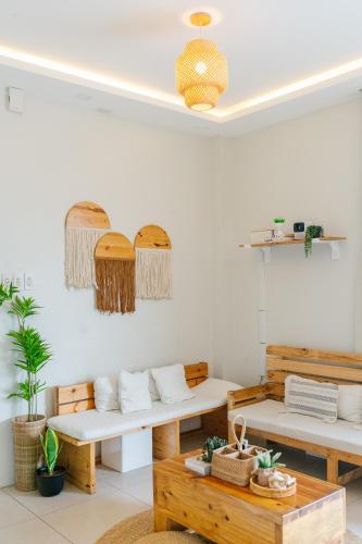 a room with two benches and a table at Bali-inspired Villa with Dipping Pool by Pallet Homes in Iloilo City