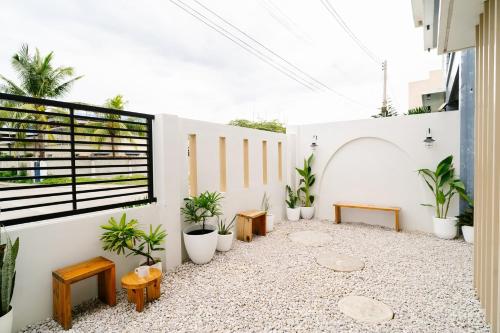 a courtyard with potted plants on a building at Bali-inspired Villa with Dipping Pool by Pallet Homes in Iloilo City