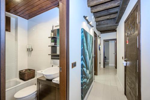a bathroom with a sink and a toilet and a tub at El Patio de Toledo in Toledo