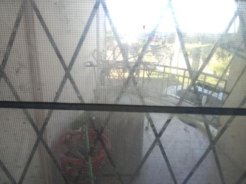 a view of a carnival ride through a window at PINTARMAN LUTONG VILLA Private Room with Shared Bathroom in Lutong
