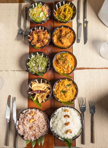a table with many different types of food on it at Clodagh Manor House by Seven Angels in Matale