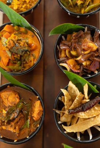 a group of bowls filled with different types of food at Clodagh Manor House by Seven Angels in Matale