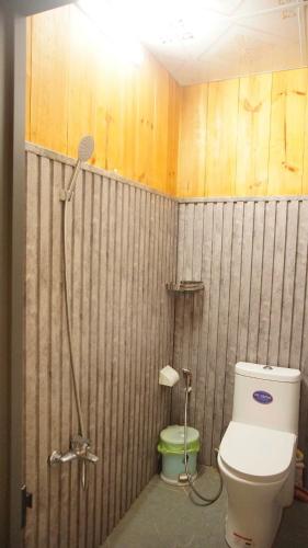 a bathroom with a toilet and a shower at Vịnh Bốn Mùa - 4 Seasons Resort in Tân Phú