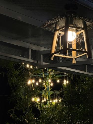 a light hanging from the side of a building with lights at Vịnh Bốn Mùa - 4 Seasons Resort in Tân Phú