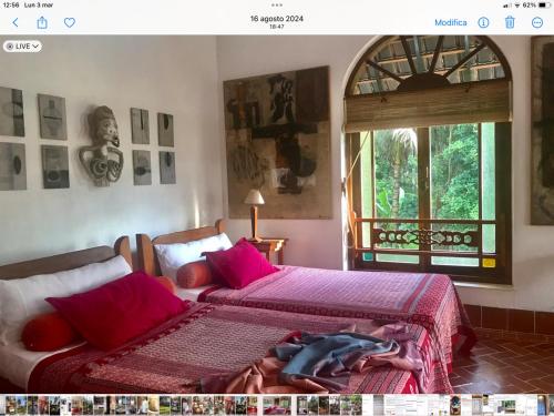 una camera da letto con due letti e una finestra di Son & Roberto a Karangasem