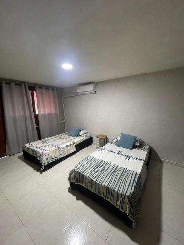 a bedroom with two beds in a room at Apartamento 52 in Barranquilla