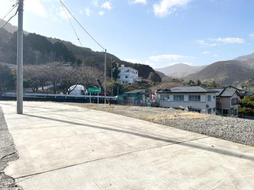 a sidewalk next to a train station with mountains at 森の風 in Higashiizu
