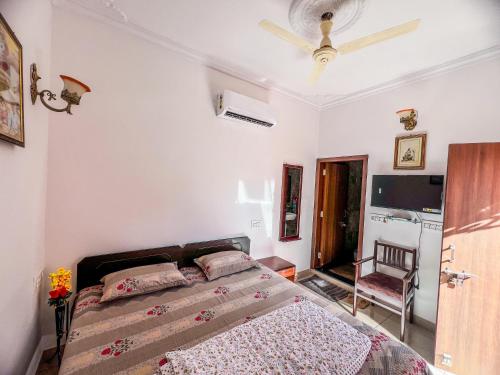 a bedroom with a bed and a chair in it at Ardas Villa Bikaner - Heritage Luxury Boutique Stay in Bikaner
