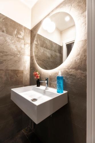 a bathroom with a sink and a mirror at Boccaccio Apartment 2 in Ravenna