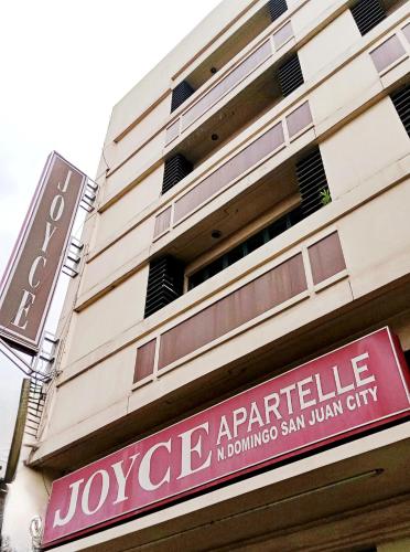 a sign on the side of a building at Joyce Apartelle San Juan in Manila