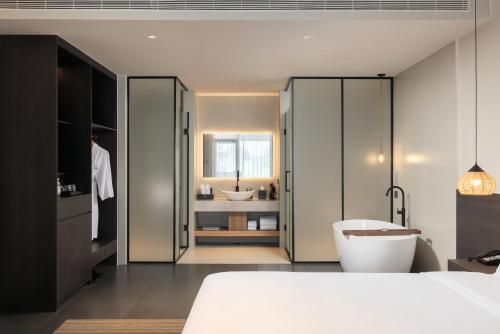 Ένα ή περισσότερα κρεβάτια σε δωμάτιο στο Hainan Ease Ocean Retreat
