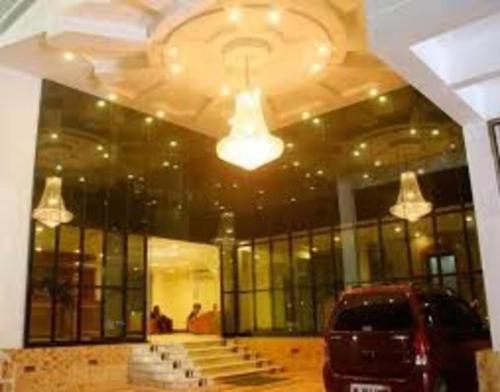a car parked in front of a building with windows at Hotel Sun World in Kanyakumari