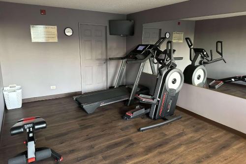 a gym with three exercise bikes in a room at Quality Inn in Ashland