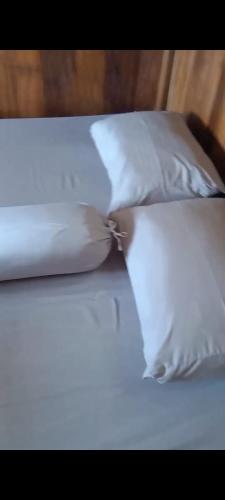 a white bed with two pillows on top of it at Villa Murah BOEKIT 3G dgn View 3 Gunung & Sunrise in Cikidang