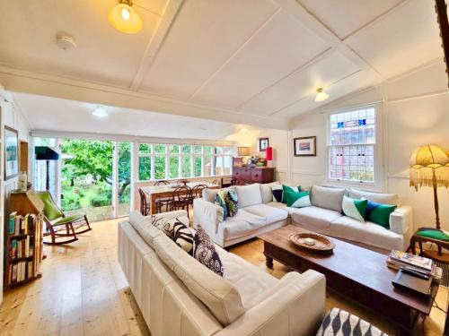 a living room with a couch and a table at Plum Blossom Cottage in Katoomba