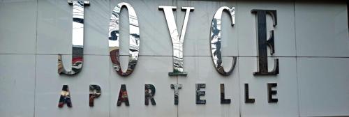 a sign for the virgin america building at Joyce Apartelle San Juan in Manila