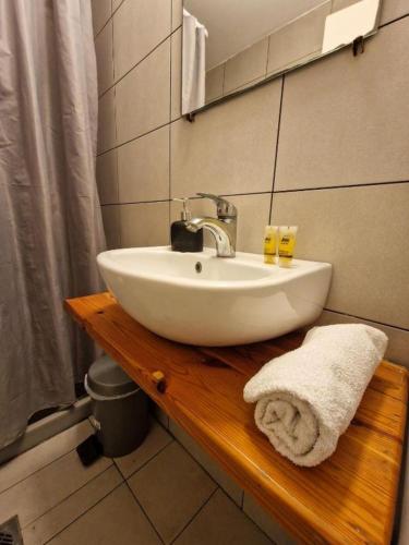 a white sink on a wooden counter in a bathroom at LaCasa Garden in Skiathos