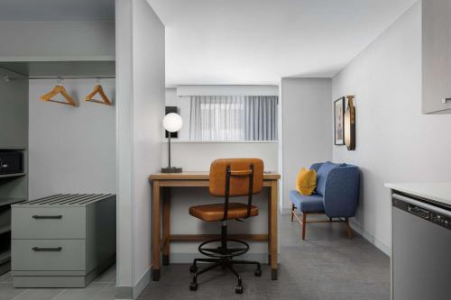 a kitchen with a desk and a chair and a desk at Homewood Suites By Hilton Newport Cincinnati in Newport