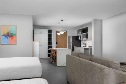 a living room and kitchen with a couch and a table at Homewood Suites By Hilton Newport Cincinnati in Newport