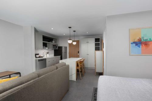 a living room and kitchen with a couch and a table at Homewood Suites By Hilton Newport Cincinnati in Newport