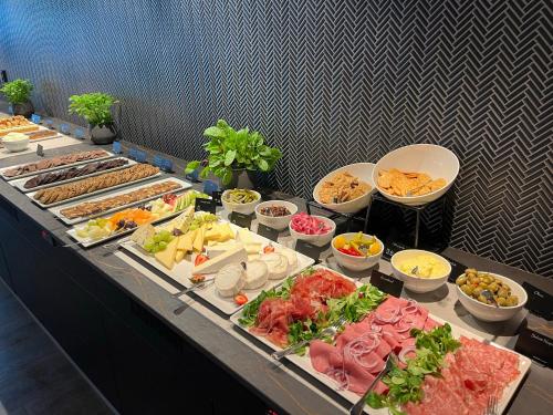 a buffet line with many different types of food at Holmen Fjordhotell in Nesbru