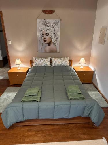 a bedroom with a large bed with two lamps at Οικία τζιβαέρι in Edessa