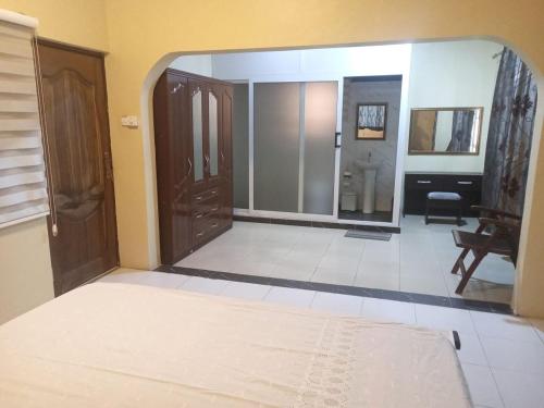 アクラにあるWelcome home to Accra Apartment for Short Stay Rentalのベッドと鏡が備わる客室です。