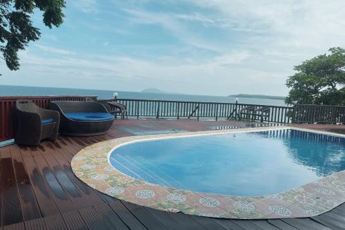 a swimming pool on the deck of a house at Blue Deep Resort powered by Cocotel in Padre Burgos