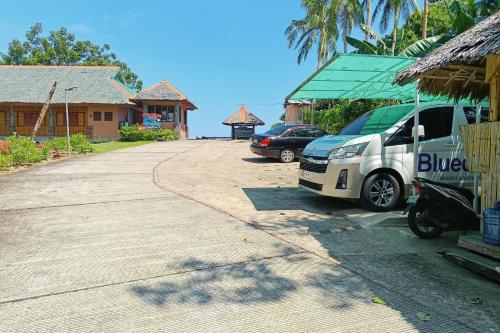 a white van parked in front of a building at Blue Deep Resort powered by Cocotel in Padre Burgos