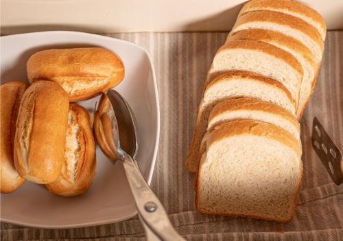 a plate with a loaf of bread and a spoon at Agriturismo Vecio Portico in Marostica