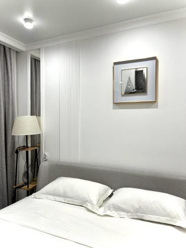 a bedroom with a bed with a picture on the wall at Juldyz in Zharkent