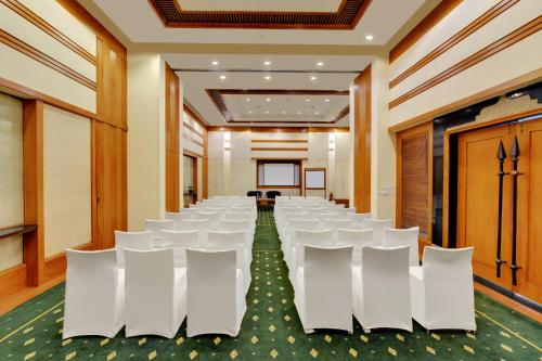 a conference room with white chairs and a table at The Fern-An Ecotel Hotel, Kochi in Cochin