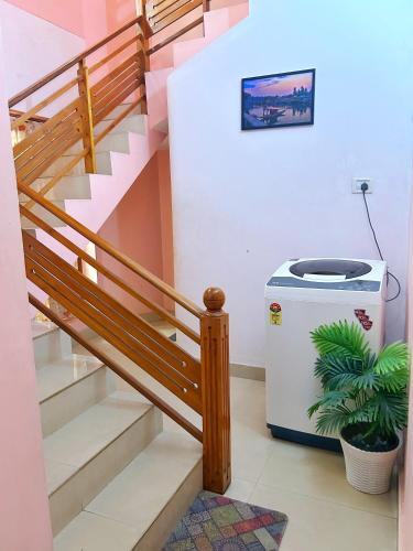 a staircase with a trash can next to a stairsuggest at La Casa Trivandrum 4 BHK AC Luxury Villa at City Centre, Just 5 kms from Airport & 3 Kms to Trivandrum Railway Station in Trivandrum