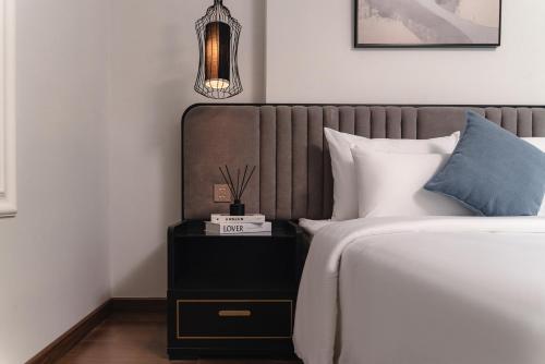 a bedroom with a bed and a nightstand next to a bed at Cloud 22Land hotel in Hanoi