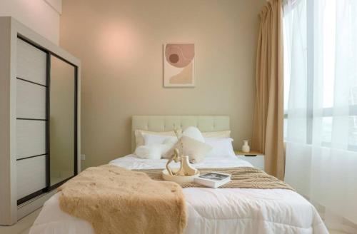 a bedroom with a large bed with a large window at Greenfield Residence Bandar Sunway in Petaling Jaya
