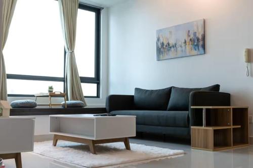 a living room with a couch and a coffee table at Greenfield Residence Bandar Sunway in Petaling Jaya